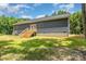 Home's backyard features a staircase leading to a back porch and a spacious lawn at 1870 Hwy 49 None, New London, NC 28127