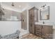 Modern bathroom featuring gray tiled shower, wooden cabinets, and light marble countertops and flooring at 1870 Hwy 49 None, New London, NC 28127