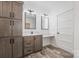 Bathroom featuring double sinks, wooden cabinets, light marble countertops, and modern lighting at 1870 Hwy 49 None, New London, NC 28127