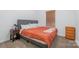 A carpeted bedroom includes a bed and minimal furniture, featuring a window with natural light at 1870 Hwy 49 None, New London, NC 28127