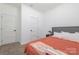 A carpeted bedroom includes a bed and minimal furniture, featuring a window and two doors at 1870 Hwy 49 None, New London, NC 28127