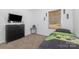 Cozy bedroom featuring a dresser, TV, neutral carpet, and a comfortable bed at 1870 Hwy 49 None, New London, NC 28127