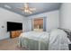 A carpeted bedroom features a window, a TV, and a ceiling fan with matching painted blue ceiling trim at 1870 Hwy 49 None, New London, NC 28127
