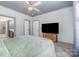 A carpeted bedroom is adjacent to the bathroom, and it features a window and a TV at 1870 Hwy 49 None, New London, NC 28127