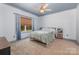 Carpeted bedroom with painted blue ceiling trim, a ceiling fan, a window, and minimal décor at 1870 Hwy 49 None, New London, NC 28127