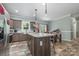 Open kitchen featuring an island with pendant lights, stainless steel appliances, and wood-look tile flooring at 1870 Hwy 49 None, New London, NC 28127