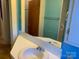 Reflection in a bathroom mirror with a vanity, sink, and faucet with doors and hallways on either side at 209 8Th Nw Ave, Hickory, NC 28601