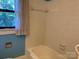 A brightly lit bathroom showing a tiled tub and walls at 209 8Th Nw Ave, Hickory, NC 28601