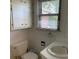 Bright bathroom features built-in cabinets and a window bringing in lots of natural light at 209 8Th Nw Ave, Hickory, NC 28601