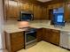 Galley kitchen featuring stainless steel appliances and wood cabinets at 209 8Th Nw Ave, Hickory, NC 28601