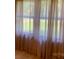 An interior view of windows covered by long, light, transparent curtains at 209 8Th Nw Ave, Hickory, NC 28601