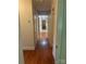 Hallway features hardwood floors and neutral walls, creating a clean and inviting pathway at 2120 Marwood Ln, Albemarle, NC 28001