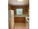 Cozy kitchen features warm wood cabinetry, white appliances, and a window offering natural light at 2120 Marwood Ln, Albemarle, NC 28001