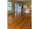 Bright living room features gleaming hardwood floors, a white front door and sunlit windows at 2120 Marwood Ln, Albemarle, NC 28001