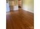 Sun-drenched living room boasts shiny hardwood floors, with a view into the next room at 2120 Marwood Ln, Albemarle, NC 28001