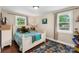 Comfortable bedroom featuring hardwood floors, two windows for natural light, and calming neutral paint at 21322 Mccall St, Cornelius, NC 28031