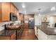 The kitchen features stainless appliances, hardwood floors, granite countertops and ample cabinet space at 21322 Mccall St, Cornelius, NC 28031