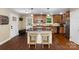 Beautiful eat-in kitchen featuring an island, stainless steel appliances, hardwood floors, and plenty of natural light at 21322 Mccall St, Cornelius, NC 28031