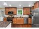 The kitchen has an island, hardwood floors, granite countertops and is well-lit at 21322 Mccall St, Cornelius, NC 28031
