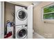 Convenient laundry area with stacked washer and dryer units, optimizing space and adding functionality to the home at 21322 Mccall St, Cornelius, NC 28031