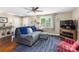 Bright living room with a ceiling fan, large window, and hardwood floors at 21322 Mccall St, Cornelius, NC 28031