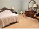 A cozy bedroom featuring neutral walls, a bed with blanket and an antique chest of drawers at 227 James Rd, Taylorsville, NC 28681