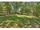 Spacious backyard with mature trees offering shade and privacy, ideal for outdoor enjoyment at 2317 Houston Branch Rd, Charlotte, NC 28270