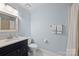 Well-lit bathroom with a sleek vanity, classic fixtures, and soft blue walls at 2317 Houston Branch Rd, Charlotte, NC 28270