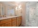 Charming bathroom with wood vanity, marble countertop, and tiled floors at 2317 Houston Branch Rd, Charlotte, NC 28270
