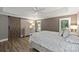 Comfortable primary bedroom with a sliding barn door, plush bedding, and shuttered windows at 2317 Houston Branch Rd, Charlotte, NC 28270