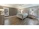 This primary bedroom features tray ceiling, shuttered windows, and sleek flooring at 2317 Houston Branch Rd, Charlotte, NC 28270