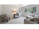 Cozy bedroom with neutral tones, a comfortable sitting area, and abundant natural light at 2317 Houston Branch Rd, Charlotte, NC 28270