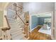 Bright foyer featuring hardwood floors, a staircase, and an adjacent room with wainscoting at 2317 Houston Branch Rd, Charlotte, NC 28270