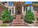 Inviting front entrance featuring a brick staircase, arched entryway, and manicured landscaping at 2317 Houston Branch Rd, Charlotte, NC 28270