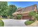 Attached two-car garage with driveway and brick exterior; well landscaped at 2317 Houston Branch Rd, Charlotte, NC 28270