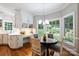 Kitchen with white cabinetry, stainless appliances, breakfast nook, and an adjacent desk space at 2317 Houston Branch Rd, Charlotte, NC 28270