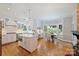 Open-concept kitchen with white cabinetry, a center island, stainless appliances, and a charming breakfast area at 2317 Houston Branch Rd, Charlotte, NC 28270
