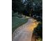 Elegant walkway illuminated with landscape lighting, surrounded by lush greenery and rock accents at 2317 Houston Branch Rd, Charlotte, NC 28270