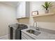 Well-organized laundry room with modern appliances, ample counter space, and sleek cabinetry at 2317 Houston Branch Rd, Charlotte, NC 28270