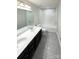 Bathroom with double vanity, dark wood cabinets and a tiled tub/shower at 2382 Drake Mill Sw Ln, Concord, NC 28025