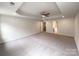 A spacious bedroom with a tray ceiling features a ceiling fan at 2382 Drake Mill Sw Ln, Concord, NC 28025