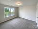 Neutral bedroom with plush carpet, natural light from double windows, and a closet at 2382 Drake Mill Sw Ln, Concord, NC 28025