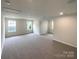 Bright bonus room with neutral carpet, recessed lighting, and large windows at 2382 Drake Mill Sw Ln, Concord, NC 28025