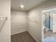 Walk-in closet with built-in shelving and a view of the shower at 2382 Drake Mill Sw Ln, Concord, NC 28025