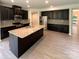 Open kitchen features dark cabinets, granite countertops, stainless steel appliances, and a large center island at 2382 Drake Mill Sw Ln, Concord, NC 28025