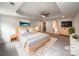 A staged primary bedroom boasts a decorative ceiling, a fan, and a large bed at 2382 Drake Mill Sw Ln, Concord, NC 28025
