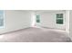 Spacious bedroom with neutral carpet and ample natural light from three windows at 259 Miramar Dr, York, SC 29745