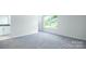 A bright room with neutral walls and carpet leading to a bathroom with granite countertops at 259 Miramar Dr, York, SC 29745