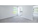 A bright bedroom with neutral walls and carpet leading to a bathroom with granite countertops at 259 Miramar Dr, York, SC 29745