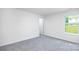 Bright room with neutral walls and carpet with a large window at 259 Miramar Dr, York, SC 29745